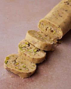 a piece of bread with pistachios on it sitting on a counter top