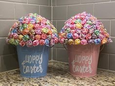 two buckets filled with candy sitting on top of a counter