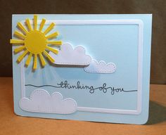 a card with the words thinking of you written on it and a sun in the sky