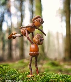 two small figurines are standing in the woods