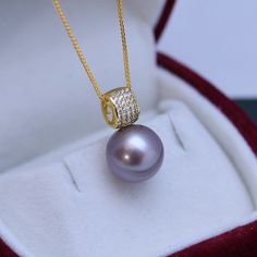 Dazzle in this stunning 11-12mm Freshwater Pearl Pendant Necklace. Handcrafted with 11-12mm freshwater pearls and blue gems, this necklace will be the perfect addition to any bridal ensemble. Boasting a remarkable luster and gleam, these pearls create a luxurious statement that will captivate the eye of any admirer. The deep purple hues of the pearls are perfectly complemented by sparkling blue gems for a truly timeless look. Elevate your style with this showstopper from House of Pearls. 11-12mm Formal Pearl Necklace With Gemstone, Adjustable Pearl Necklace, Elegant Purple Jewelry With Pearl Pendant, Luxury Purple Elegant Pearl Necklace, Elegant Purple Round Pearl Necklace, Purple Necklace With Pearl Pendant, Elegant Purple Pearl Pendant Necklace, Celine Earrings, Baroque Pearls Necklace