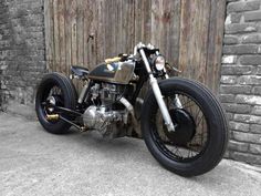 a motorcycle parked next to a brick wall