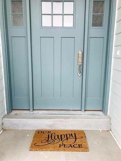 a blue front door with a happy welcome mat