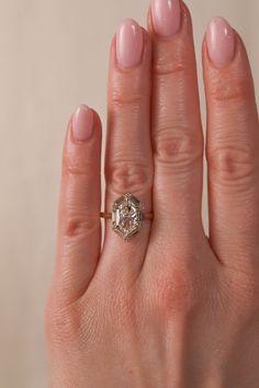 a woman's hand with a diamond ring on it