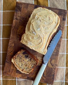 peanut butter and banana bread on a wooden cutting board with a knife next to it