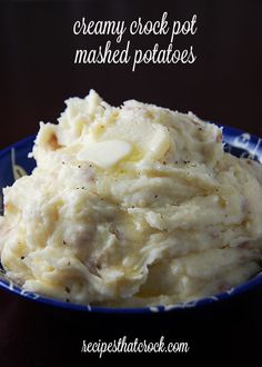 mashed potatoes in a blue bowl on a wooden table with the words creamy crock pot mashed potatoes