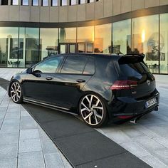 a black car parked in front of a building