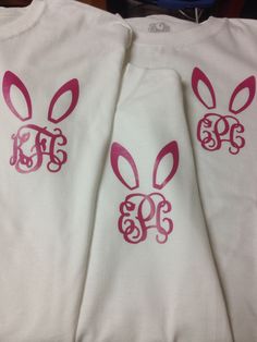 two white shirts with pink bunny ears and monogrammed initials on the front, one is