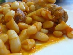 pasta with meatballs and sauce on a white plate