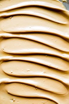 a pan filled with frosting sitting on top of a counter