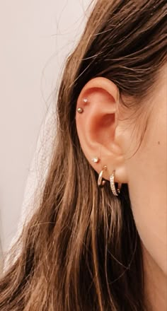 a close up of a person wearing ear piercings