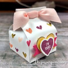 an origami box with a pink bow on it and i'm yours