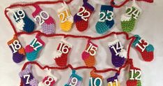 crocheted christmas stockings with numbers hanging from strings