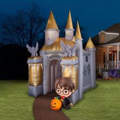 an inflatable halloween castle with a girl holding a pumpkin