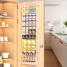 the pantry door is open to reveal an assortment of food items in its bins