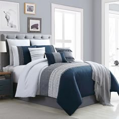 a bed with blue and white comforters in a bedroom