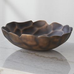 a large metal bowl sitting on top of a white counter