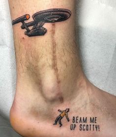 a foot with a tattoo on it that says beam me up scotty and an image of a flying saucer