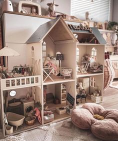 a doll house with furniture and accessories on the floor