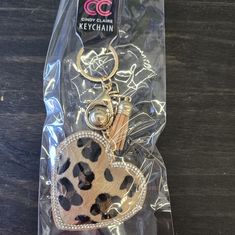 the keychain has a heart shaped animal print on it's front and back