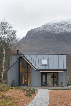 a house in the mountains with a metal roof