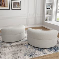 two white chairs sitting on top of a rug in a living room next to a window