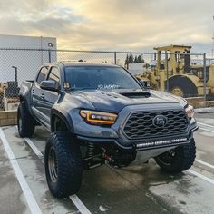 a large gray truck parked in a parking lot