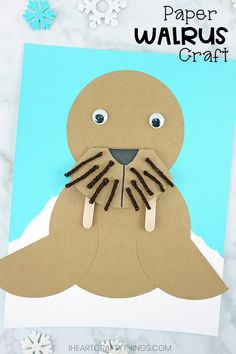 a paper walrus craft is shown with snowflakes