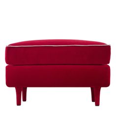 a red footstool with white piping on the top and bottom, in front of a white background