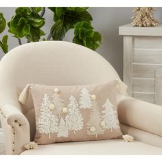 a white chair sitting next to a potted plant