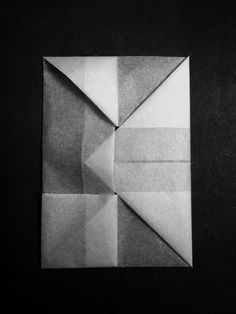 an origami piece is shown in black and white, which appears to be folded