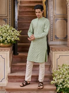 An elegant sage green kurta, ideal for morning celebrations, combines minimalism with sophistication. Its features include a tasteful mandarin collar and subtle diagonal embroidery in white thread, adding a touch of simplicity to the design. KURTA LENGTH (XS) - 40PAYJAMA LENGTH (XS) - 39In every size, the top and bottom lengths are an additional half inch. Mens Kurta Wedding Guest, Sage Green Kurta Men, Kurta Collar Designs For Men, Green Kurta Pajama Men, Haldi Outfits Men, Man Kurta Design, Kurta For Haldi Function Men, Poses For Men In Kurta, Kurta Mens Design