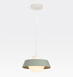 a white and grey light hanging from a ceiling fixture with a circular shade on it