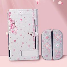 an electronic device with pink flowers on it and two buttons in the middle, next to a