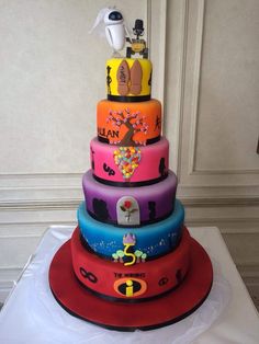 a multi - tiered cake with cartoon characters on it's sides and bottom