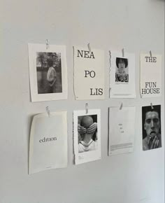 several pieces of paper hanging on a wall with pictures pinned to it's sides