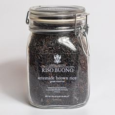 a jar filled with brown rice sitting on top of a table