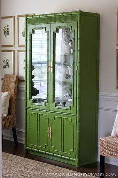 a green china cabinet in a living room