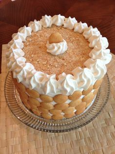 a close up of a cake on a glass plate with a wooden table in the background