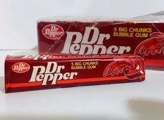 two packages of dr pepper gum sitting next to each other on a white counter top