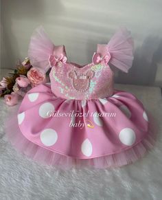 a pink and white polka dot tutule dress with sequins on it