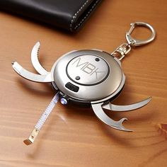 a metal keychain that is on top of a table