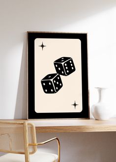 two dices are on top of each other in front of a white vase and chair