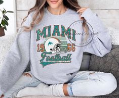 Miami Football Sweatshirt  Retro Miami Dolphin Sweatshirt  Dolphin Est 1966 Crewneck  Miami Fan Gift  Sunday Football 1 Easy 30 day return policy Miami Dolphins Sweatshirt, Eagles Football Team, Retro Style 90s, Eagles Hoodie, Philly Eagles, Miami Football, Eagles Football, Gifts For Football Fans, Football Sweatshirt