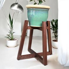 a potted plant sitting on top of a wooden stand