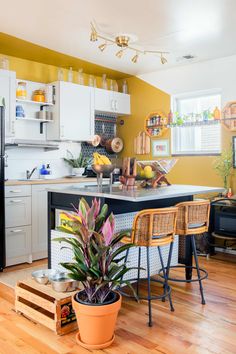 a kitchen with yellow walls and wooden floors