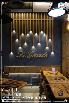 a restaurant with wooden tables and chairs in front of a sign that reads la grande