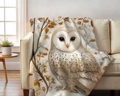 an owl sitting on top of a white couch