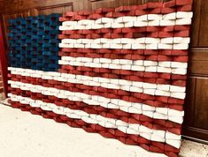 an american flag made out of bricks on the floor in front of a wall with wood paneling