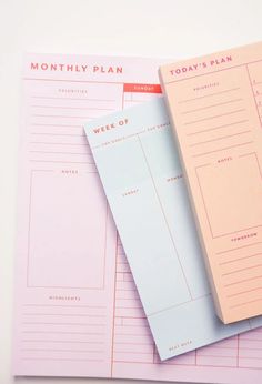 two pink and blue planner pages sitting on top of each other